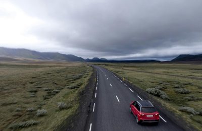 Red-Car-Driving-On-Country-Roa